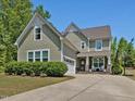 Charming two-story home featuring a well-maintained lawn, manicured bushes, and a welcoming front porch at 1701 Bodwin Ln, Apex, NC 27502