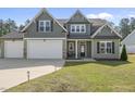 Beautiful two-story home with a spacious driveway and manicured front lawn at 178 Ashpole Trl, Clayton, NC 27520