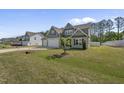 Craftsman-style home with a two-car garage and a neatly landscaped yard at 178 Ashpole Trl, Clayton, NC 27520