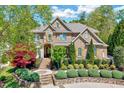Beautiful brick home with meticulously landscaped front yard and inviting entrance, exuding curb appeal at 187 Stoney Creek Way, Chapel Hill, NC 27517