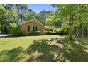 An inviting brick home nestled within a serene, tree-filled landscape for a peaceful setting at 2001 Lovdal Dr, Raleigh, NC 27613