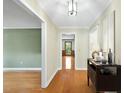 Bright foyer with gleaming hardwood floors and an inviting entryway console table at 2001 Lovdal Dr, Raleigh, NC 27613