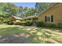 Traditional brick home with manicured shrubs, offering a welcoming and classic curb appeal at 2001 Lovdal Dr, Raleigh, NC 27613