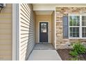 Close-up of a home's front entryway showing the front door with decorative glass and stone wall accents at 217 Griffis Dr, Stem, NC 27581