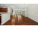 Bright open-concept layout with hardwood floors, fireplace, and easy access to outdoor patio at 245 Kylemore Cir, Cary, NC 27513