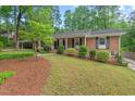 Beautiful brick home with lush green lawn and mature landscaping adding to the home's curb appeal at 2508 Sevier St, Durham, NC 27705