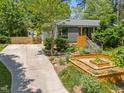 A beautifully landscaped yard and a long driveway leads to this charming home at 2529 Remington Rd, Raleigh, NC 27610