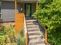 Inviting front entrance with modern steel railing and a charming wood landing at 2529 Remington Rd, Raleigh, NC 27610