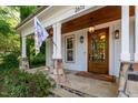 Close-up of the front porch showcasing stone accents and a wooden front door at 2613 Bedford Ave, Raleigh, NC 27607