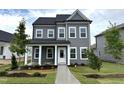 Charming two-story home with gray siding, white trim, covered porch, and a well-manicured lawn and landscaping at 2872 Quarry Rd # 166, Rolesville, NC 27571