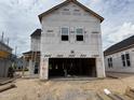 Exterior view of a two-story home under construction showing the garage with open framing at 2872 Quarry Rd # 166, Rolesville, NC 27571