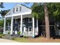 Charming two-story home with a covered porch and mature trees at 300 S Pine St, Benson, NC 27504