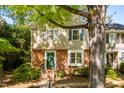 Traditional townhouse with brick facade, light siding, green shutters, and a cozy front entrance at 3029 Wycliff Rd, Raleigh, NC 27607