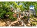Inviting two-story townhouse featuring brick accents, neutral siding, and picturesque landscaping at 3029 Wycliff Rd, Raleigh, NC 27607