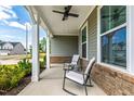 Cozy covered porch with seating, perfect for relaxing and enjoying the neighborhood view at 303 Forestview Crest Way, Fuquay Varina, NC 27526