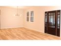 Bright and airy living room featuring hardwood floors and contemporary lighting fixture at 305 W Waddell St, Selma, NC 27576