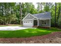 Charming single story home with attached garage and lush lawn surrounded by mature trees at 3258 Yorkshire Cir, Sanford, NC 27332