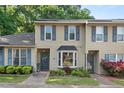 Inviting townhome exterior featuring charming curb appeal with well-maintained landscaping and a classic facade at 35 Stonewall Way, Durham, NC 27704