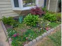 Lush front yard featuring a variety of colorful flowers and plants creating an inviting curb appeal at 35 Stonewall Way, Durham, NC 27704