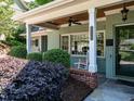 Inviting front porch with swing, rocking chair, and stylish brick accents at 3504 Rock Creek Dr, Raleigh, NC 27609
