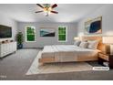 Bright main bedroom features plush carpet, ceiling fan, and abundant natural light from two windows at 351 Gilman Ln # 109, Raleigh, NC 27610