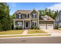 Classic home with inviting front porch and two-car garage provides ample parking at 403 Prestwood Dr, Hillsborough, NC 27278