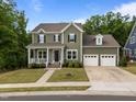 Traditional two-story home with a welcoming front porch and a convenient two-car garage at 403 Prestwood Dr, Hillsborough, NC 27278