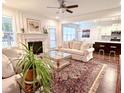 Bright and inviting living room featuring fireplace, neutral furniture, and open access to kitchen at 409 Eagle Ct, Henderson, NC 27536