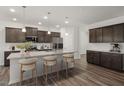 Bright kitchen featuring a granite island with seating and stainless steel appliances at 413 Providence Springs Ln, Fuquay Varina, NC 27526