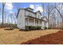 Charming two-story gray home with a welcoming front porch and landscaped with pine straw at 42 Turkey Ct, Timberlake, NC 27583