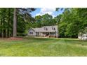 Lovely home with a well-manicured lawn and mature trees, providing a serene setting at 450 S Stratford Dr, Henderson, NC 27537