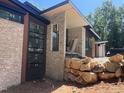 View of the stone and wood exterior featuring large windows and clean lines at 481 Brook Green Ln # 23, Pittsboro, NC 27312
