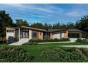 Stylish modern home with wood and stone accents, an attached garage, and a paved walkway to the entrance at 481 Brook Green Ln # 23, Pittsboro, NC 27312