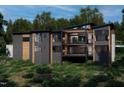 Rear exterior of modern home showing multiple balconies, large windows, and hillside landscaping at 481 Brook Green Ln # 23, Pittsboro, NC 27312