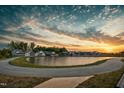 Scenic community with a pond surrounded by walking trails and residential homes at 5009 Megara Run, Raleigh, NC 27603