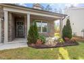 Inviting front porch with manicured landscaping and colorful flowers, creating a warm and welcoming entrance at 52 Brunello Ct, Clayton, NC 27527