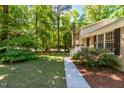 Well-maintained lawn and landscaping highlight the home's exterior, leading to a charming entrance at 526 Colony Woods Dr, Chapel Hill, NC 27517