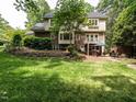 Spacious backyard featuring a patio area, lush green lawn, and mature trees at 5317 Deep Valley, Raleigh, NC 27606