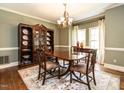 Elegant dining room featuring hardwood floors, chandelier, and a china cabinet at 5317 Deep Valley, Raleigh, NC 27606