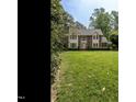 Beautiful two-story home with brick and siding exterior, manicured lawn, and mature trees at 5317 Deep Valley, Raleigh, NC 27606