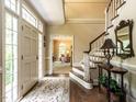 Elegant foyer with hardwood floors, staircase, and view into the living room at 5317 Deep Valley, Raleigh, NC 27606