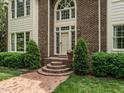 Charming front entrance with brick steps, decorative shrubs, and a classic door at 5317 Deep Valley, Raleigh, NC 27606