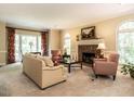 Bright living room with large windows, a brick fireplace, and neutral decor creating a warm and inviting atmosphere at 5317 Deep Valley, Raleigh, NC 27606
