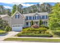 Charming two-story home with a well-manicured front yard and attached two-car garage at 533 Opposition Way, Wake Forest, NC 27587