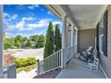 Charming front porch view showcasing white railings and landscaping, perfect for relaxing outdoors at 533 Opposition Way, Wake Forest, NC 27587