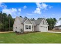 Charming home with a well-manicured lawn, appealing curb appeal, and an attached garage at 56 Birchtop Cir, Zebulon, NC 27597