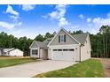 Lovely home with a well-kept lawn, great curb appeal, and an attached two-car garage at 56 Birchtop Cir, Zebulon, NC 27597