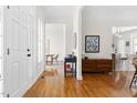 Inviting foyer with hardwood floors, elegant console table, and views into the dining and living spaces at 608 Elin Ct, Hillsborough, NC 27278