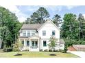 Beautiful two-story home with lush landscaping and a well-maintained lawn at 642 The Parks Dr, Pittsboro, NC 27312