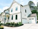 Beautiful two-story home with lush landscaping and a three car garage at 642 The Parks Dr, Pittsboro, NC 27312